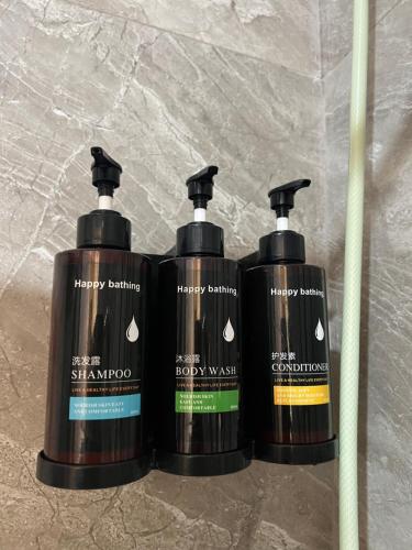 a group of three shampoo bottles sitting on a counter at C View Resort in Sipalay