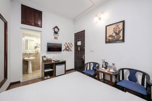 a bedroom with a bed and a desk and a sink at A25 Hotel - 197 Thanh Nhàn in Hanoi