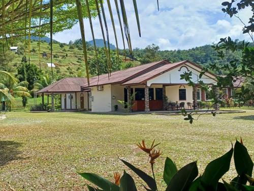 a house with a large yard in front of it at Lemuni Retreat & Training Centre - Kerling, Selangor in Kerling