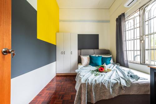 a bedroom with a bed with a bowl of fruit on it at 7 min to Sunway Pyramid Deluxe Room Shared House at PJS9 in Petaling Jaya