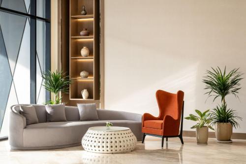 a living room with a couch and a chair and a table at DoubleTree by Hilton Vientiane in Vientiane