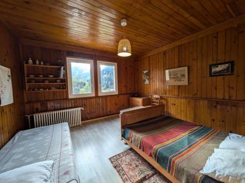 a bedroom with a bed in a wooden room at Appartement 2 chambres, 5 pers., cœur de village avec parking - FR-1-342-323 in Beaufort
