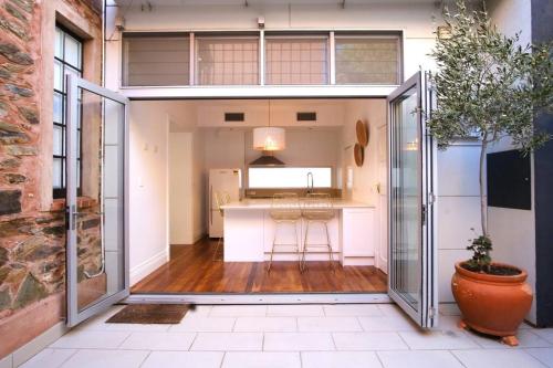 an open kitchen with an open sliding glass door at Spacious CBD terrace - 3 beds, wifi and parking in Adelaide