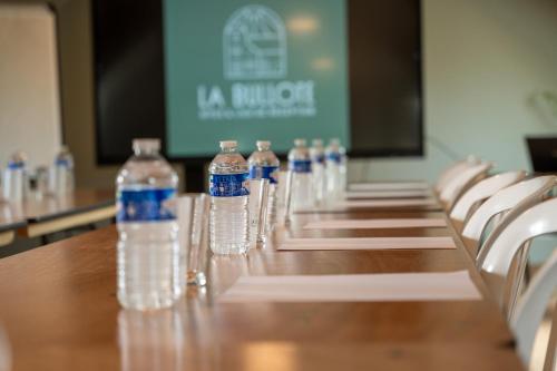 a row of bottles of water sitting on a table at La Bullote - Gîtes - Paris Roissy CDG in Villeneuve-sous-Dammartin
