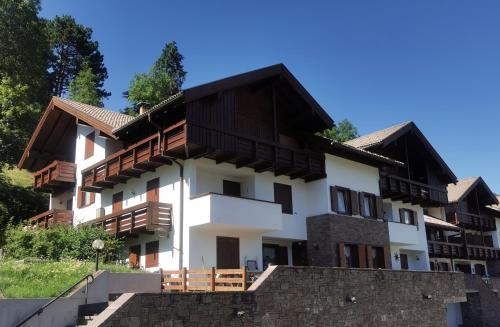 un bâtiment avec des balcons en bois au sommet dans l'établissement La casa di Marco, à Cavalese