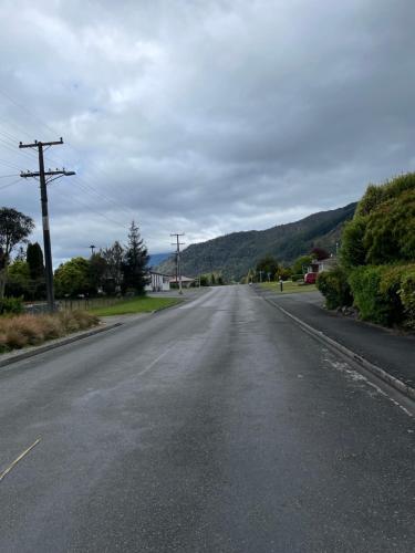 an empty road with mountains in the distance at Mataki Motel in Murchison