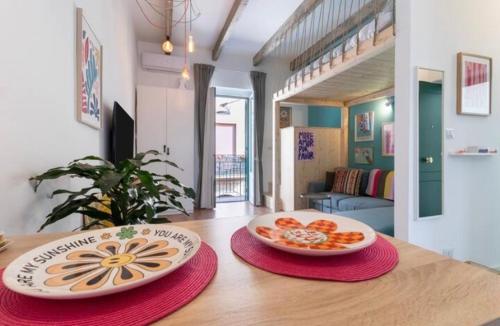 two plates of food sitting on a wooden table at TheTinyHouse 70128 in Bari