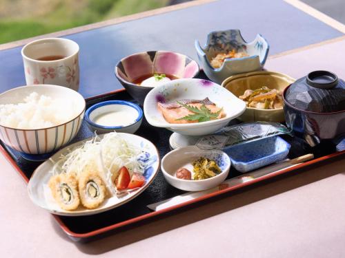 a tray with various dishes of food on a table at Hotel Areaone Wadayama in Asago