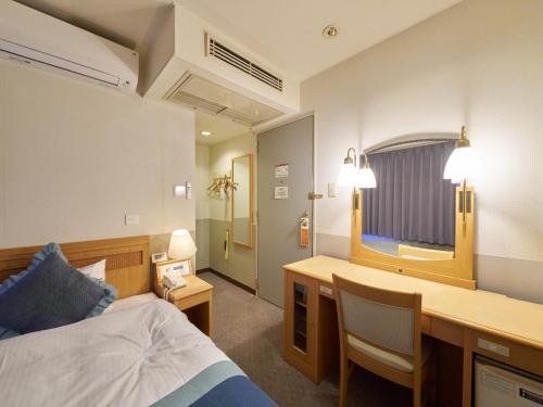 Postel nebo postele na pokoji v ubytování Hotel Areaone Wadayama