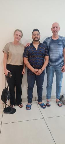 a group of three people standing next to a wall at Hotel SB Residency in Amritsar