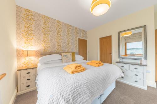 a bedroom with a bed with two towels on it at Grizedale View in Coniston