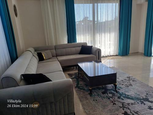 a living room with a couch and a coffee table at Villa Ayla in Fethiye
