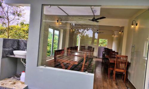 a kitchen and dining room with a table and chairs at The Autumn by Maat Hotels in Vagamon