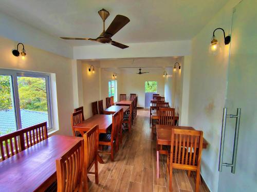 a dining room with wooden tables and chairs at The Autumn by Maat Hotels in Vagamon