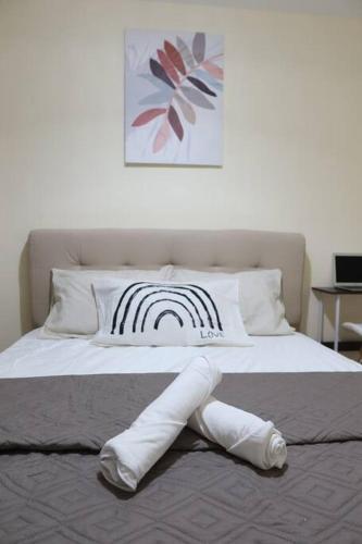 a bed with a comforter that has abowsigunigunigun at Skyline Home Antipolo in Antipolo