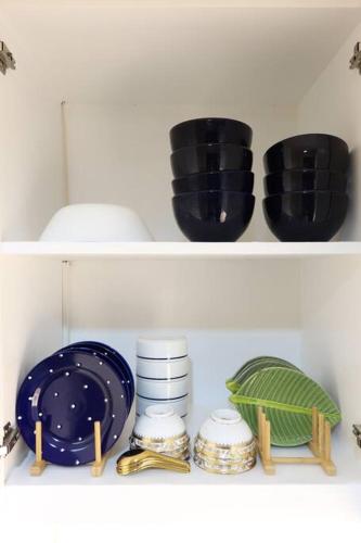 three black bowls and plates on a shelf at Skyline Home Antipolo in Antipolo