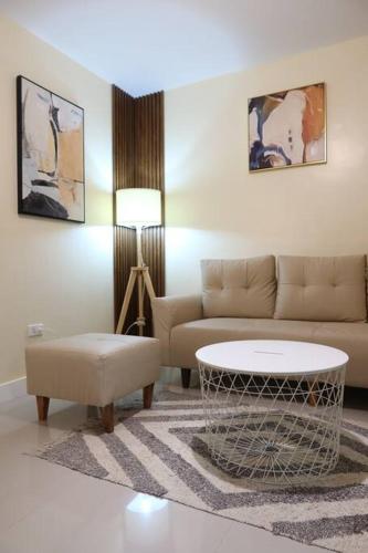 a living room with a couch and a table at Skyline Home Antipolo in Antipolo