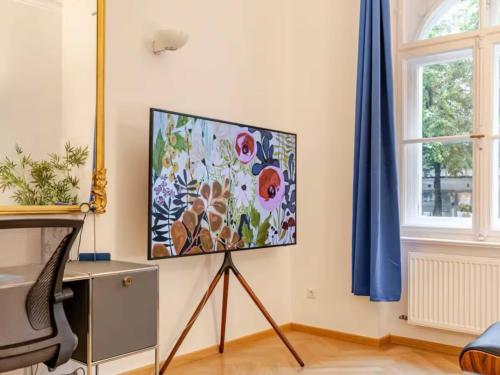 a flat screen tv sitting on a stand in a room at TheGallery in Munich