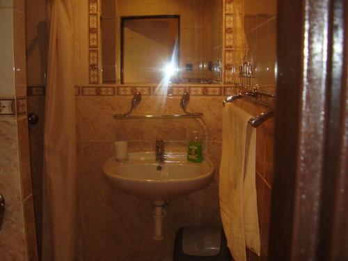 a person taking a picture of a sink in a bathroom at Penzion Havran in Ždiar