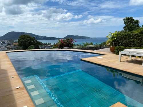a swimming pool with a view of the water at Andaman Hill Pool Seaview in Patong Beach
