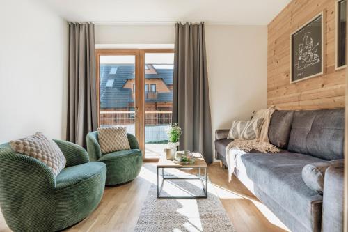 a living room with a couch and two chairs at Apres Ski Bachleda - LoftAffair Collection in Zakopane