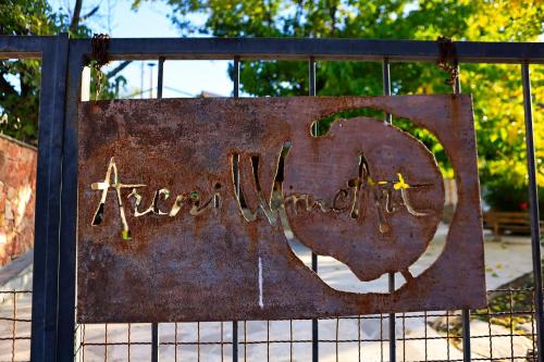 a rusty sign on a fence with the words happy anniversary at Areni Wine Art in Areni