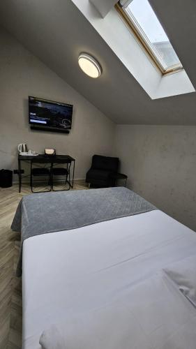 Postel nebo postele na pokoji v ubytování Hotel Amfiteatar