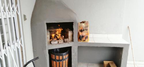 a fireplace in a living room with a fire place at Ocean Vibes Studio Apartment in Margate
