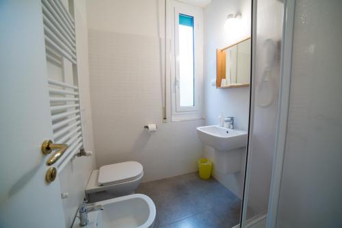 bagno bianco con servizi igienici e lavandino di Hotel Villa Gloria a Varazze