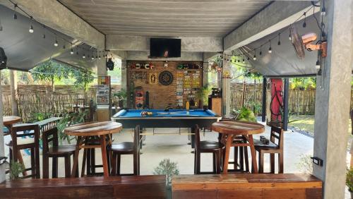 a bar with a pool table on a patio at Seven 50s in Pai