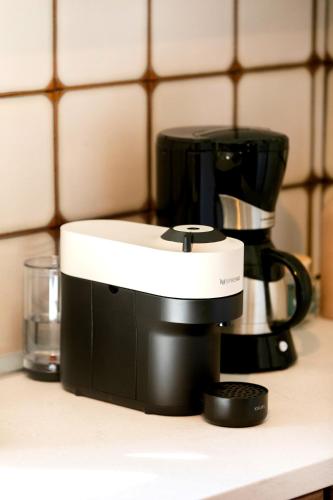 a black and white coffee maker sitting on a counter at Villa Natsi in Aspróyia