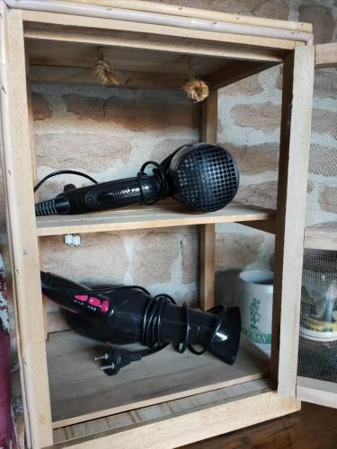 a microphone in a wooden shelf with a microphone at La ferme du Grand Faubourg in Pont-de-Vaux