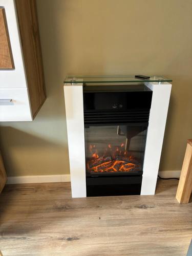 a fireplace in a room with food cooking in it at Haus Nina near Willingen and Winterberg in Olsberg