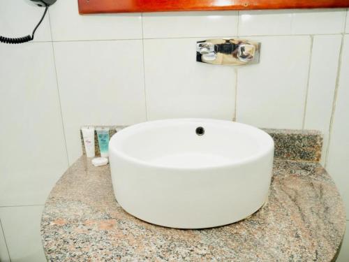 a white sink on a counter in a bathroom at Nile Village Hotel & Spa in Jinja