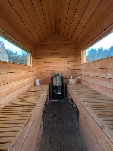 an empty sauna with wooden benches in a cabin at La Petite Maison dans la Prairie in Pepinster