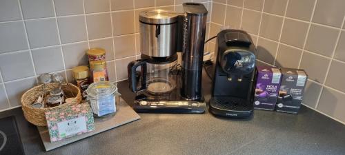 a kitchen counter with a coffee maker on a counter top at Villa Strömma Värmdö - Sthlm archipelago, comfortable & fully equipped, 35 min from city center in Värmdö