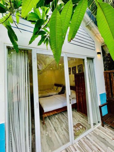 a room with a bedroom with a bed and a window at Hoang Phuc resort in Rạch Giá