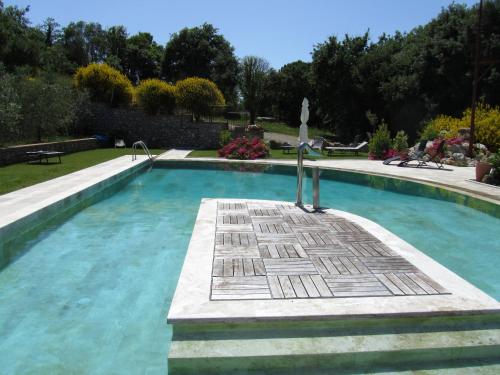 a swimming pool in a yard with at Agriturismo Borghetto Il Montino in Rapolano Terme