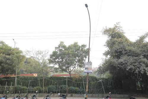 a group of motorcycles parked next to a fence at Hotel Nirvana Suites in New Delhi