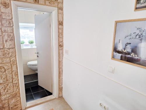 a bathroom with a staircase leading to a toilet at St Peter's Heritage House in Trogir