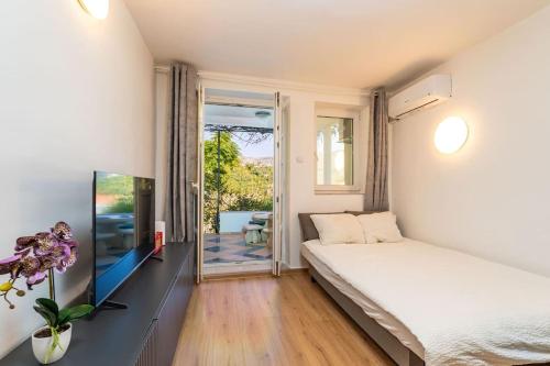 a bedroom with a bed and a sliding glass door at Casa Claudia in Zaton