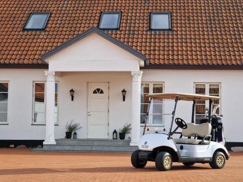 a golf cart parked in front of a house at Fontänens Bed & Breakfast in Trelleborg