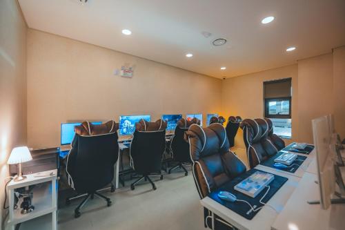 a conference room with chairs and desks and computers at Wonju city hotel in Wonju