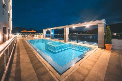 a swimming pool on top of a building at night at Wonju city hotel in Wonju