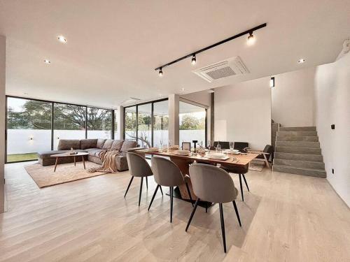 a large living room with a table and chairs at Maerim Peaceful in Ban Pa Muang