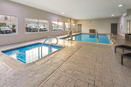 a pool in a hotel room with a swimming pool at Candlewood Suites Chambersburg by IHG in Chambersburg