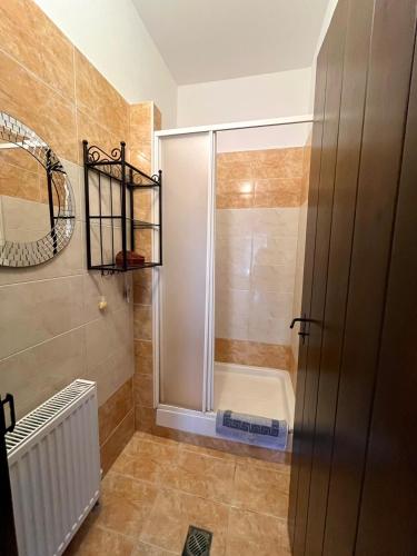 a shower with a glass door in a bathroom at Stone Villa Rokosini in Vourvourou