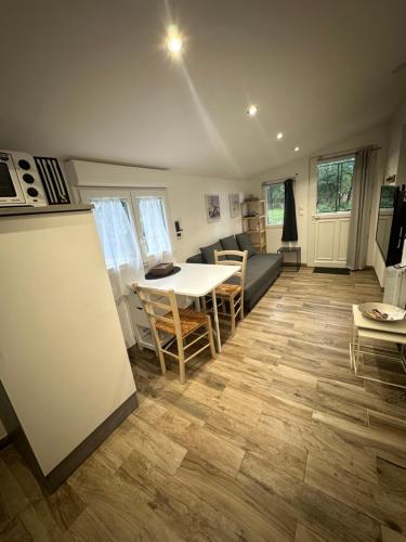 a kitchen and living room with a table and chairs at La maisonnette de Chantecoucou in Le Cannet-des-Maures