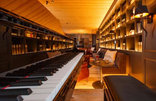 a large keyboard in a room with a table at Hotel Piz Buin Klosters in Klosters