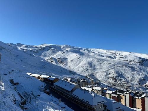 a train is parked on a snow covered mountain at Cabaña con encanto y vistas increíbles!! in Sierra Nevada